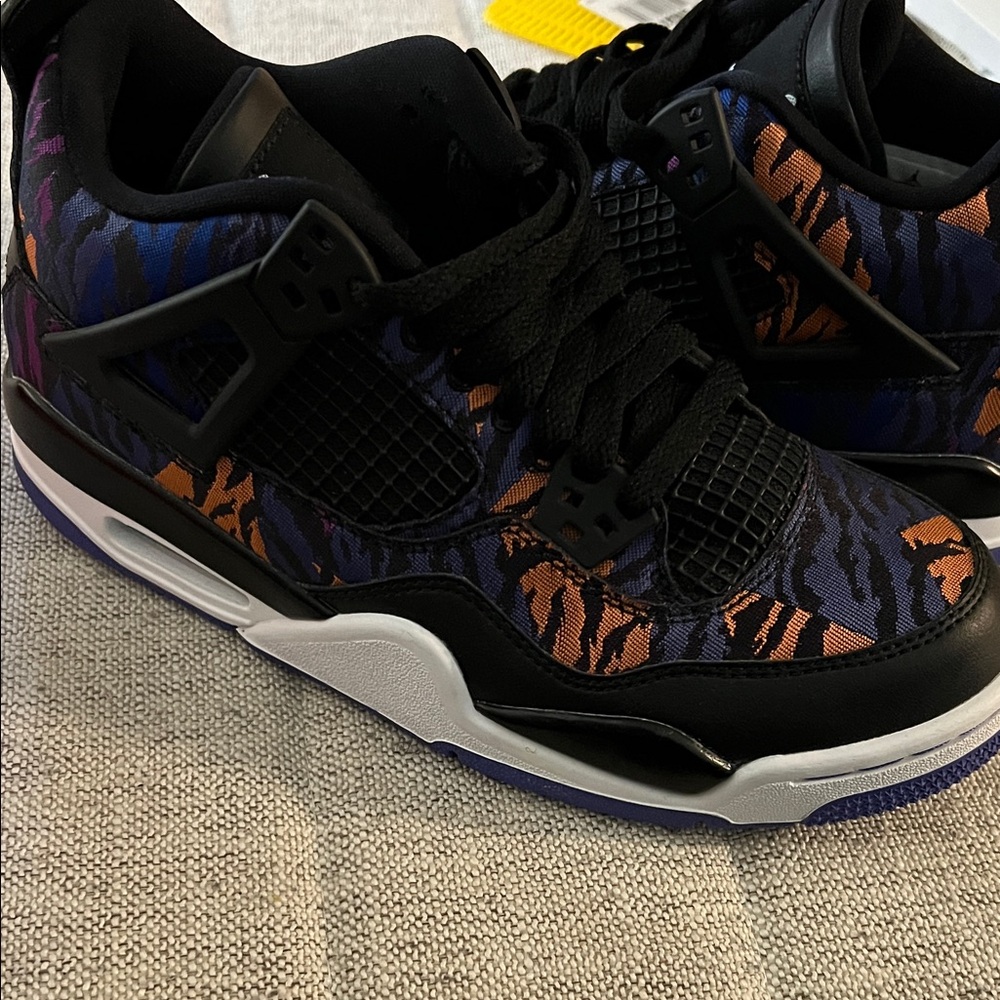 Jordan 4 “Black Rush Violet” Black and Orange Patterned Sneakers